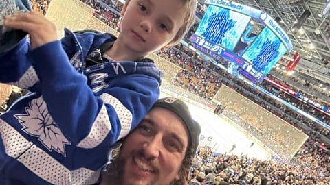 Evan Blackman and his son at a hockey game