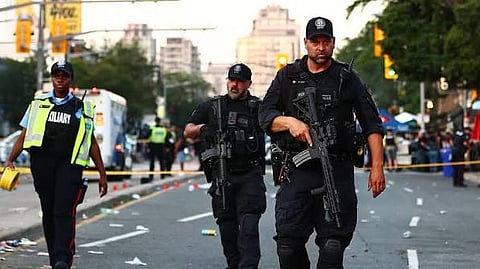 Officers clear the scene after a mass shooting at a Latin street festival on Saturday.
