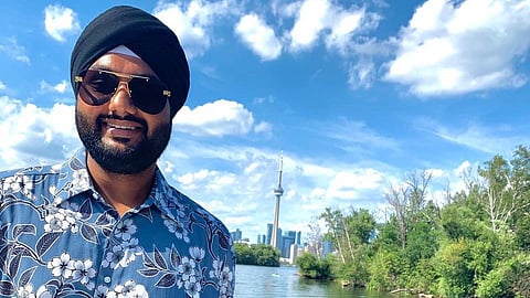 Hardeep Grewal poses by the Toronto city skyline