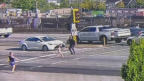 A man exits his vehicle and reaches for a young child who had walked into traffic at Highway 10 and 148 Street in Surrey on July 21.