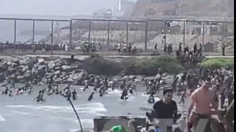 Thousands of Moroccan migrants surge over the border between Morocco and the Spanish autonomous city of Ceuta