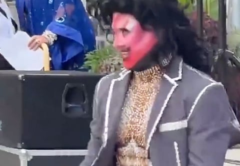 A drag performer in heavy makeup and a sequined bodysuit performs during the Davie Village Pride Festival on Davie Street in Vancouver on August 2, 2026.
