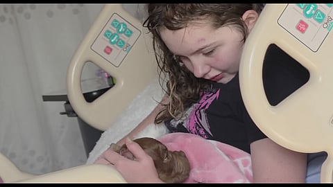 Maya Gebala, the 12-year-old survivor of the February 10 Tumbler Ridge Secondary School shooting, gently pets a new puppy from her hospital bed at BC Children’s Hospital in Vancouver. Nearly six months after suffering critical head and neck injuries, she continues to show remarkable progress in her recovery.