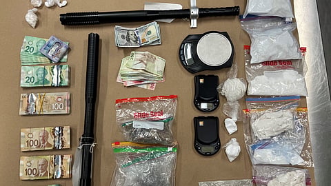 Seized items including cash, cocaine, fentanyl, and batons from a Calgary drug bust