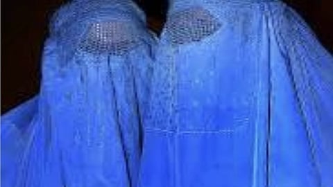 Two Afghan women wearing the mandatory burqa.