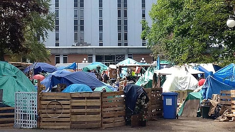 Tent camp set up on the lawn of Victoria’s provincial courthouse, April 2016. One of several BC camps organized by known coordinators with supporters and supplies brought in, the high-profile camp drove the BC government to take over more hotels and motels for occupants who refused or were expelled from shelters. 