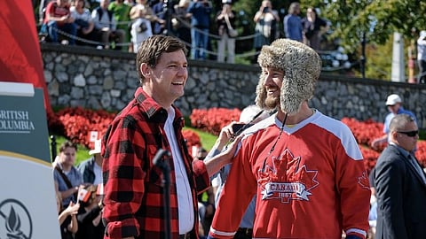 BC Premier David Eby congratulates rapper Shane Kimber on his performance at a news conference to protest US tariffs at Victoria’s inner harbour, Sept. 8, 2026. 