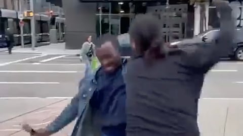 A women allegedly attacking a street preacher in front of Edmonton's City Centre mall. 