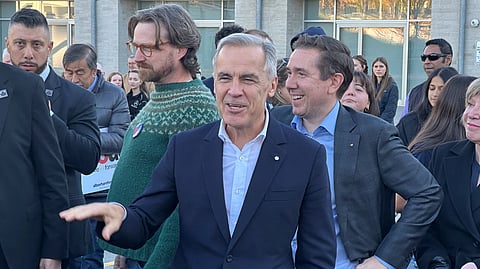 Prime Minister Mark Carney (centre) and Liberal MP Corey Hogan (right) in Calgary on October 15. 