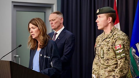 Premier Danielle Smith, Canadian Minister of National Defense David McGuinty and Major-General L.W. Rutland speaking to reporters. 