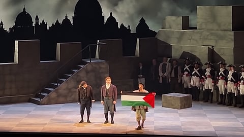 Calgary Opera has removed a singer from its production of Tosca after he displayed a Palestinian flag during the opening-night curtain call.