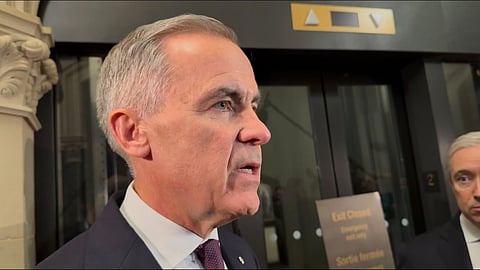 Mark Carney speaks to reporters on immigration