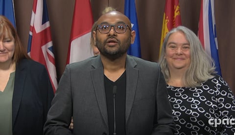 Syed Hassan (Migrant rights network) speaking at a Parliament hill presser, May 2024
