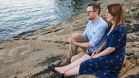 Megan Sheldon and her husband Johan Hoglund sit on the rocks along the North Shore.