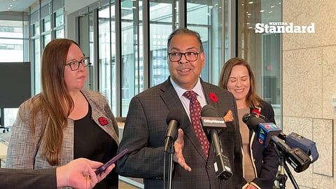 Alberta NDP leader Naheed Nenshi, and MLAs Christina Gray and Kathleen Ganley speaking to reporters following the electoral boundaries committee meeting. 