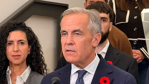 Mark Carney speaks to reporters in Montreal