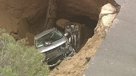 WATCH: THAT SINKING FEELING: Mom and daughter trapped in giant sinkhole