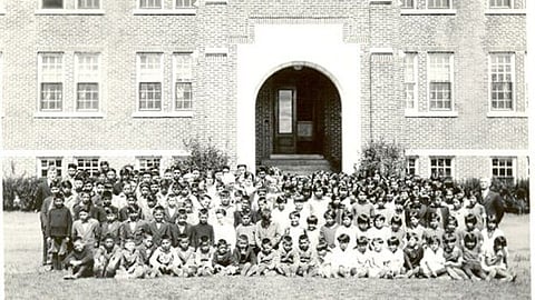Indigenous children, assembled for a group picture at a residential school.