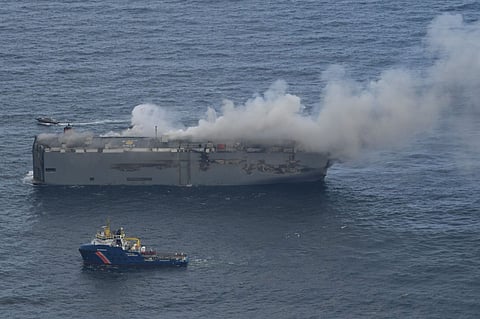 Crews working to put out fire on ship carrying 2,800 vehicles in North Sea, caused by electric car