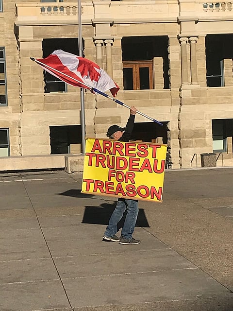 Defying crackdown, hundreds march against lockdowns in Calgary