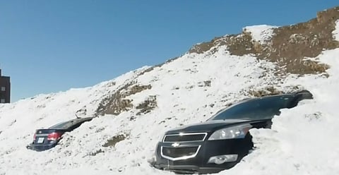 Two cars found in a parking lot snow pile
