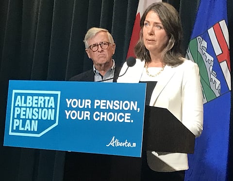 Flanked by former Alberta treasurer Jim Dinning, Premier Danielle Smith announces public consultations on her proposed Alberta Pension Plan.