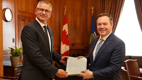 Premier Jason Kenney and Finance Minister Travis Toews hold a copy of Budget 2020.