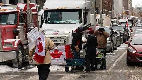 Trucks and protesters mass in downtown Ottawa during an ongoing protest against vaccine mandates on Feb. 4, 2022.