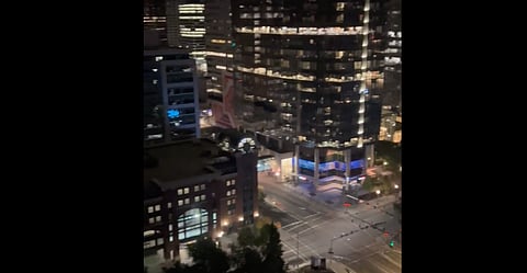 Parachuters jump off of downtown Calgary building
